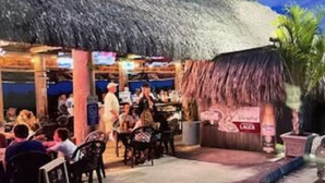 An outdoor restaurant with thatched roofs and outdoor seating. - FLAMINGO COTTAGE summer fun. Pool, boating, fishing lobster season.  (Summerland Key)