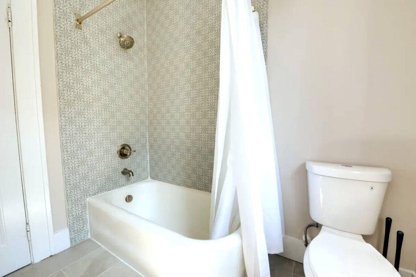 Un baño con bañera, inodoro y cortina de ducha.