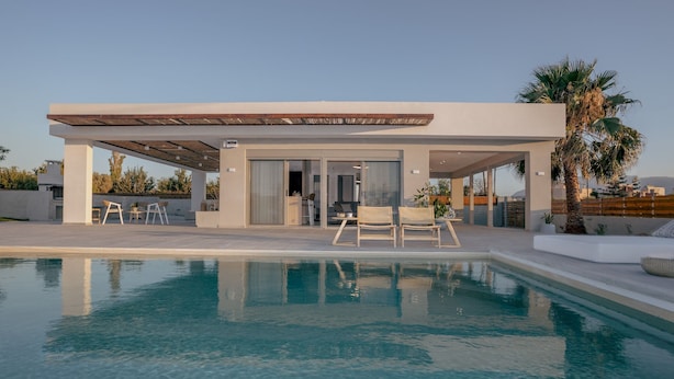 A modern house with a pool, covered patio, and outdoor seating. - Athena Luxury Villa by Estia (Gazi)
