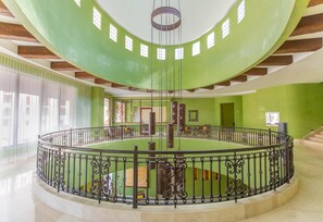A spacious atrium with a circular floor plan, a central column, and a decorative railing. - 1604 4BR/5BA Oceanfront PH Loreto @ Danzante Bay (Ensenada Blanca)