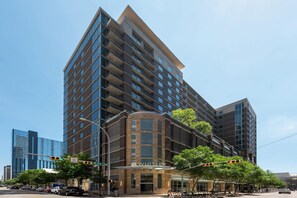 A multi-story hotel with a prominent entrance, large windows, and a modern architectural design. - Austin Modern 1BD 1BA Apartment (Austin)