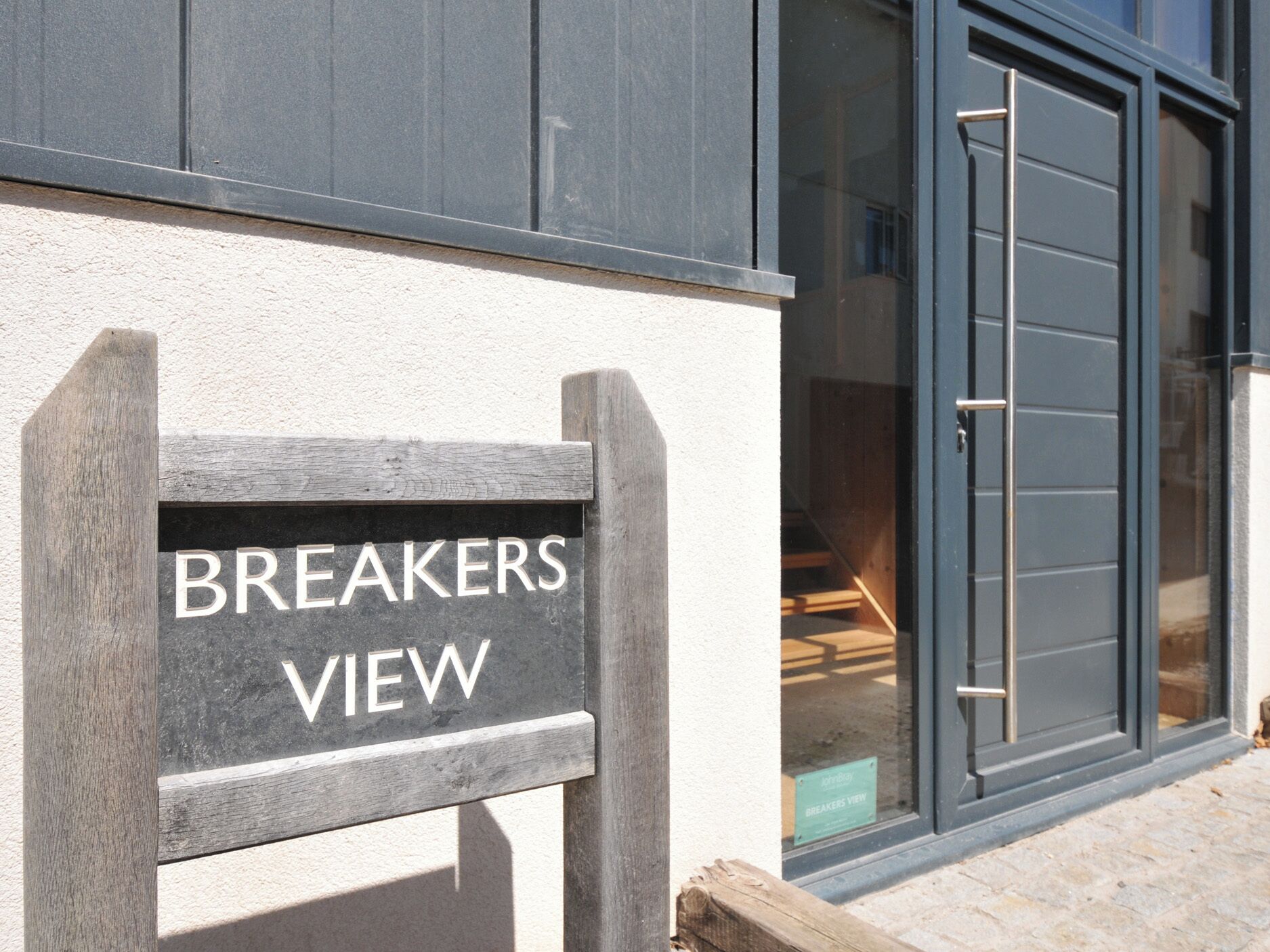 A sign reading 'BREAKERS VIEW' on a building facade.