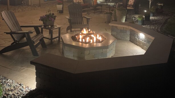 A patio area with a fire pit, outdoor furniture, and string lights. - Plan for EAA ! Executive ranch, only 13 miles away  (Neenah)