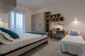 A bedroom with two beds, a desk, and a bookshelf. - La Casetta di Dado by Wonderful Italy (Turin)