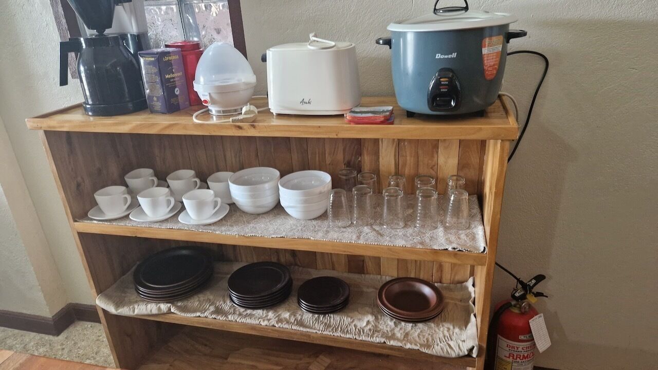 A kitchen counter with various appliances and utensils.