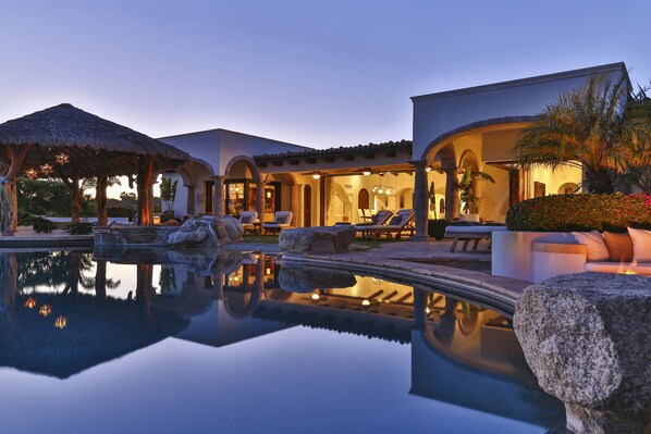 Relax by the serene pool surrounded by the resort's elegant architecture and comfortable seating areas.