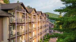 A multi-story hotel with balconies, a brick pathway, and surrounding greenery. - Hotel Solina Resort & Spa (Solina)
