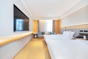 A hotel room with two beds, a TV, a small table with a lamp, and a window with curtains. - Ji Hotel Qingdao Xinduxin Changsha Road (Qingdao)