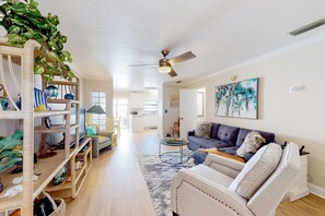 Relax in this stylish living area with a sofa, coffee table, and area rug.