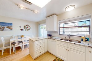 Enjoy meals in the kitchen with dishwasher and dining area with table and chairs.