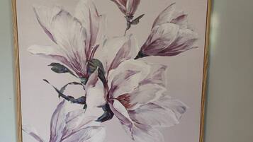 A framed painting of magnolia flowers.