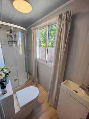 Shower, hair dryer, towels, toilet paper
