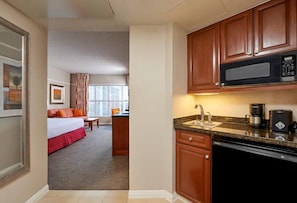 Enjoy a compact retreat with a kitchenette, seating area, and city view.