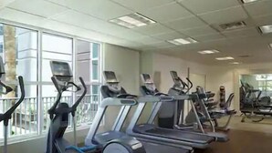 A gym with treadmills, ellipticals, and stationary bikes arranged in rows. - Las Vegas | Vegas Weekend Stay | Pool & Resort (Las Vegas)