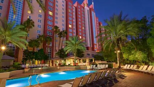 A hotel with a swimming pool and lounge chairs. - Las Vegas | Vegas Weekend Stay | Pool & Resort (Las Vegas)