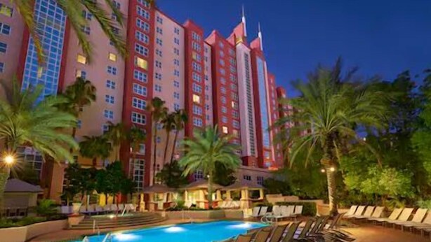 A hotel with a swimming pool and lounge chairs. - Las Vegas | Vegas Weekend Escape | Pool & Resort | 2BR (Las Vegas)