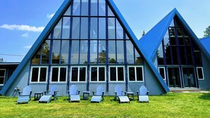 A modern building with a triangular roof and large windows. - NewVida Preserve (Jay)