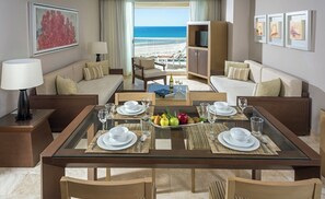 Enjoy a beachside retreat with a dining table, sofa, and TV, perfect for unwinding in style.