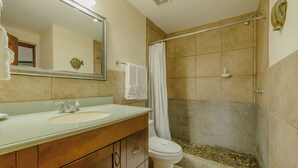 A bathroom with a sink, mirror, toilet, and shower. - Casa de Amor B-58                                                             . (Villa El Carmen)