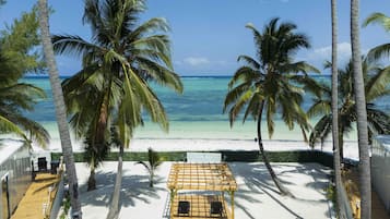 On the beach, white sand, sun-loungers, beach umbrellas
