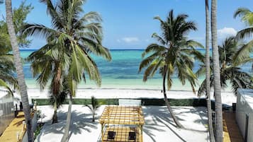 On the beach, white sand, sun-loungers, beach umbrellas