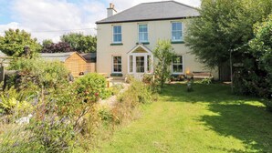 A two-story house with a garden in front.