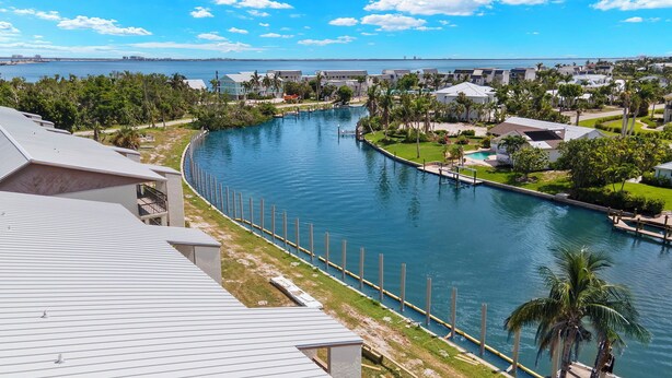 A river running through a residential area with houses on both sides.
