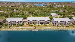 A resort with multiple-story buildings, a marina, and a view of the surrounding landscape.
