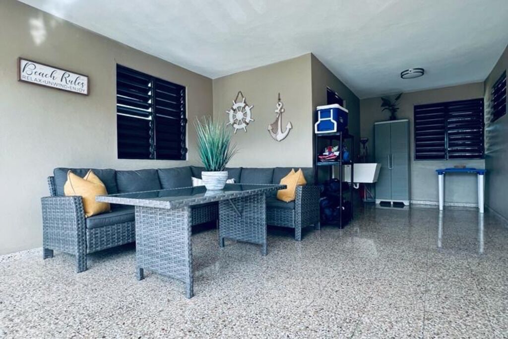 A living area with a sofa, a coffee table, and a potted plant.