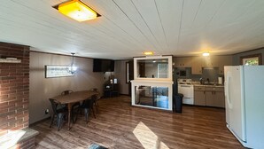A spacious kitchen with a refrigerator, stove, and sink. - Cozy ORV Cabin Retreat with Firepit & Fast WiFi (West Branch)