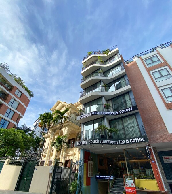 A multi-story building with a sign for 'Pegasi Apartments & Travel' and 'Matéa South American Tea & Coffee'. - Pegasy Apartments & Travel (Hanoi)