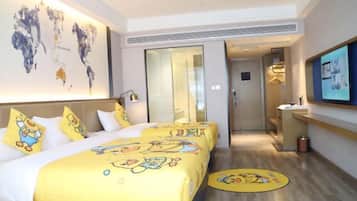 A hotel room with a large bed, a desk, and a television.