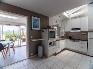 Enjoy cooking in this well-lit kitchen with a central island, oven, and microwave.