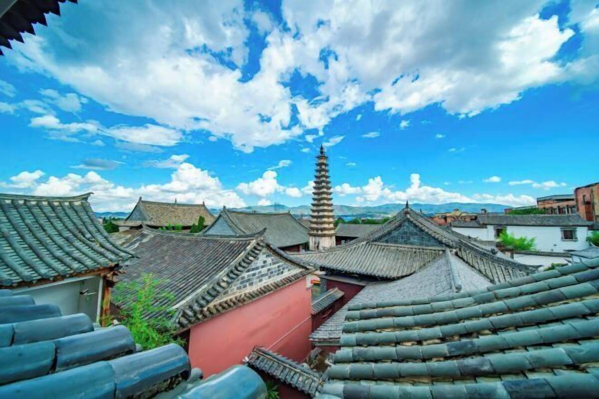 Traditional architecture with tiered roofs and a pagoda-like structure.