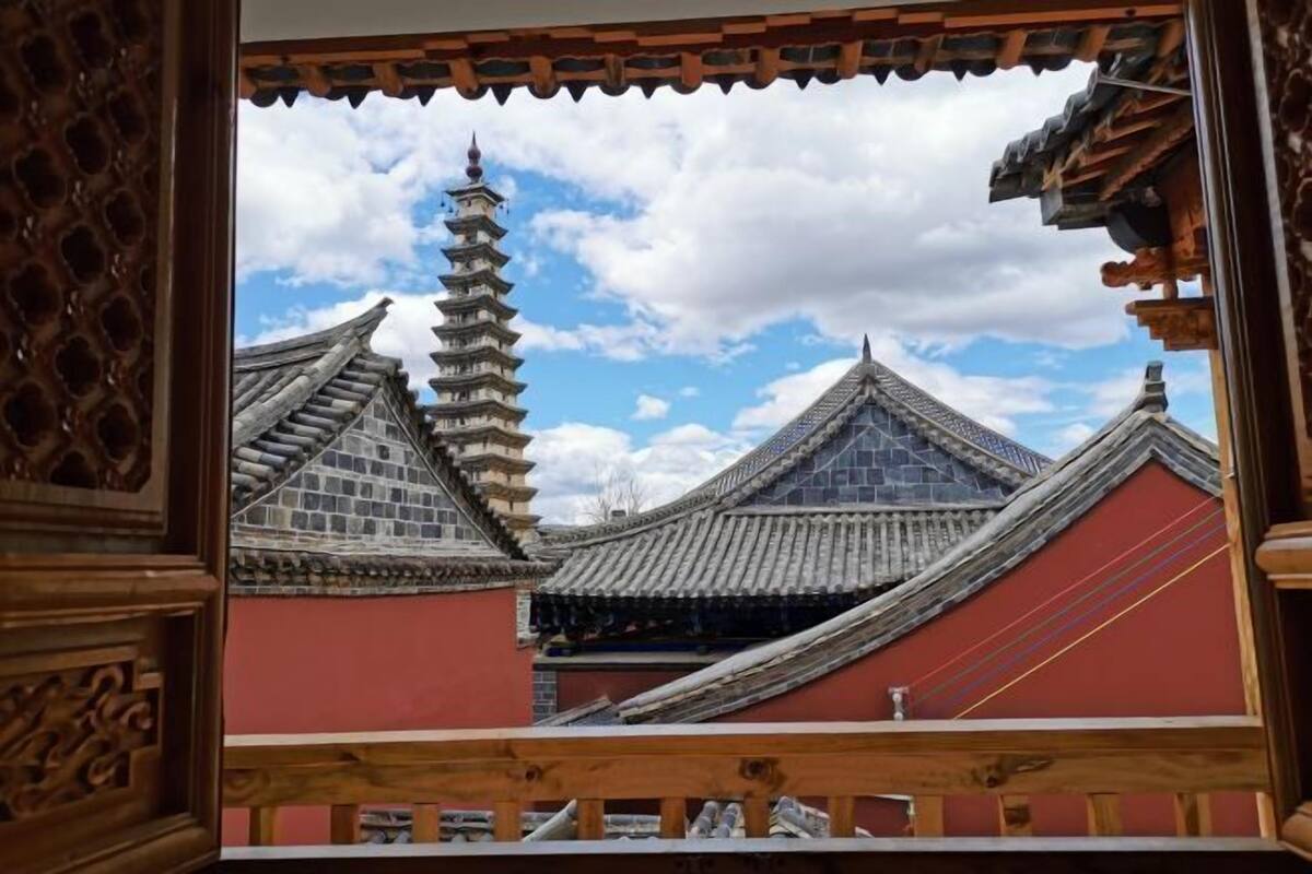 A traditional building with a pagoda-style tower and steeply pitched roofs.