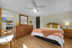 A bedroom with a bed, dresser, and a television in the corner. - Pet friendly, hdtv°Fireplace°Netflix°Backyard (Deep gap)