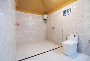 Bathroom features a shower area, toilet, and towel rack.