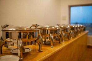 Enjoy a meal at our communal dining area, where hot dishes are served from a row of buffet stations.