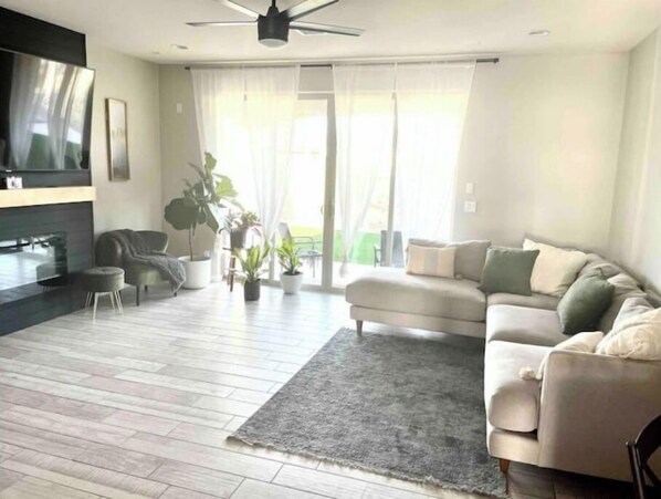 Relax in this inviting living room with a comfortable sofa, flat-screen TV, and cozy seating area.