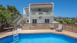 A two-story building with a swimming pool, wooden deck, and outdoor seating. - Holiday Home 'Villa Melenia 1' with Private Pool, 5 Minutes from the Beach, Wi-Fi & Air Conditioning (??. ?e?a??a)