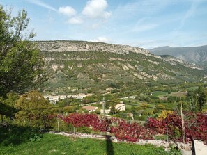 A mountainous landscape with a village nestled in the valley.
