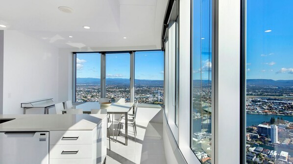 A modern kitchen with large windows offering a city view.