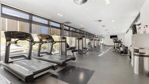 A modern gym with treadmills, elliptical machines, and weight equipment. - Stunning 2 Bedroom Ocean Views Apartment (Surfers Paradise)