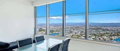 A conference room with a large window offering a city view.