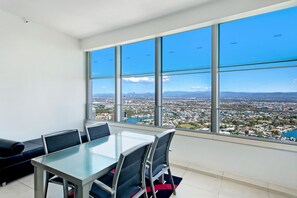 A conference room with a large window offering a city view.