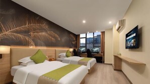 A hotel room with two beds, a large feather artwork on the wall, a TV on the wall, and a view of the city through the window. - 24 Hours Banxing Hotel (Guiyang)
