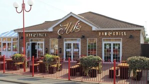 A brick building with a sign that reads "Bar & Grill". - Captivating 3-bed Caravan at Golden Palm Skegness (Skegness)