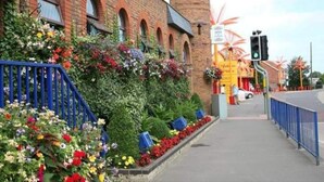 A building with a brick facade, arched windows, and a cylindrical tower. - Captivating 3-bed Caravan at Golden Palm Skegness (Skegness)