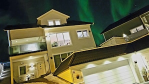 A multi-story house with a garage and a visible window.