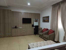 Deluxe Suite | Living area | 22-inch plasma TV with cable channels